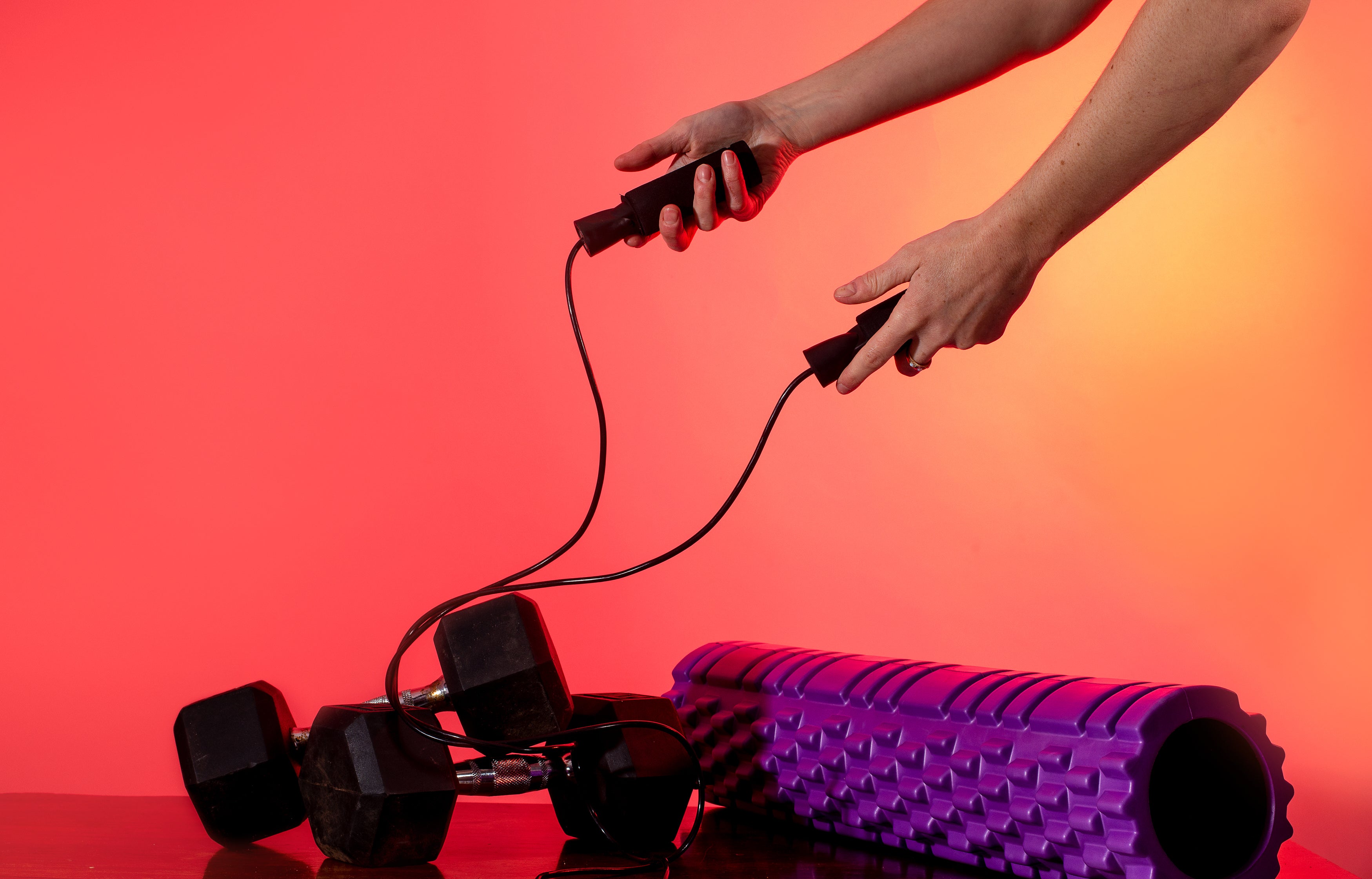 two-dumbells-and-a-foam-roller-on-a-wooden-table.jpg